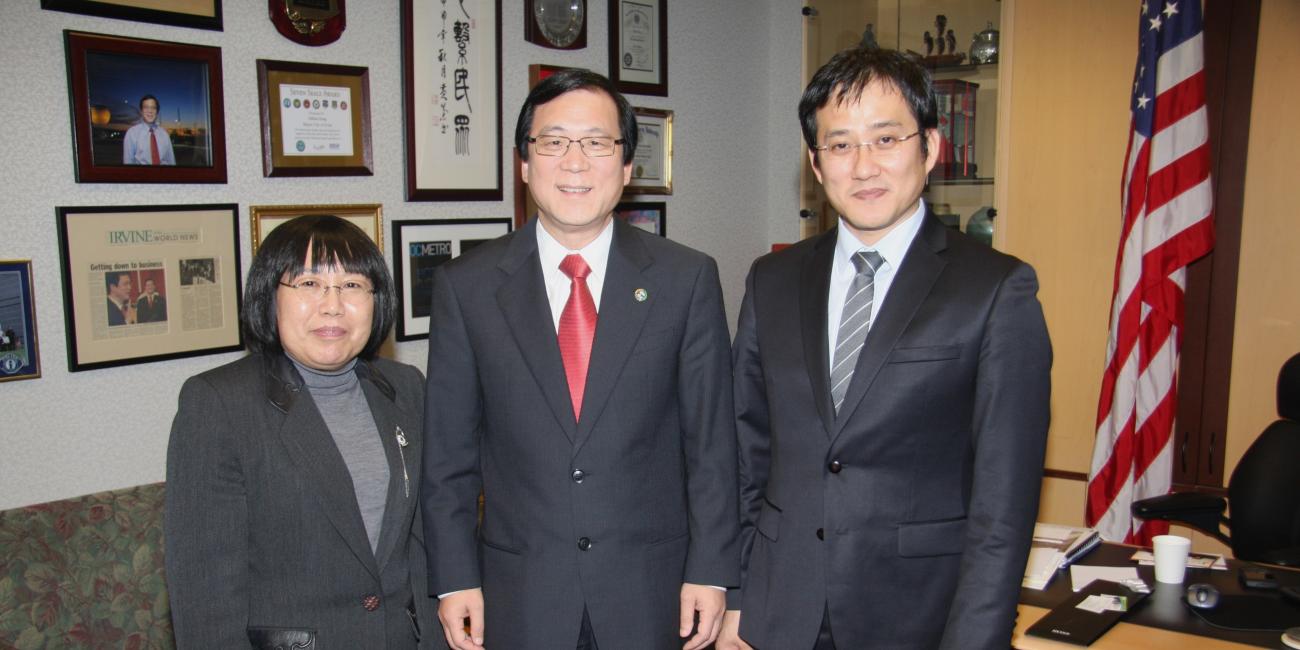 Photograph of smiling adults posing in an office