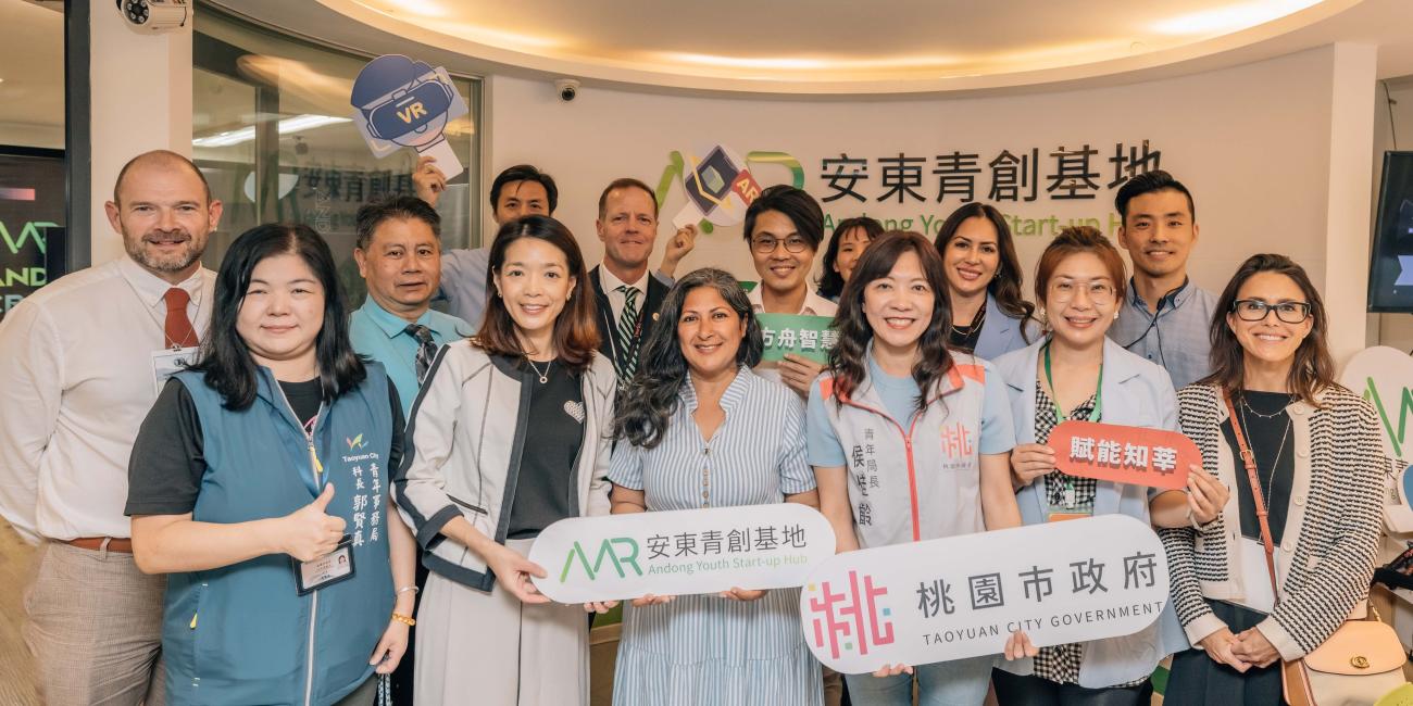Group of adults smiling holding signs