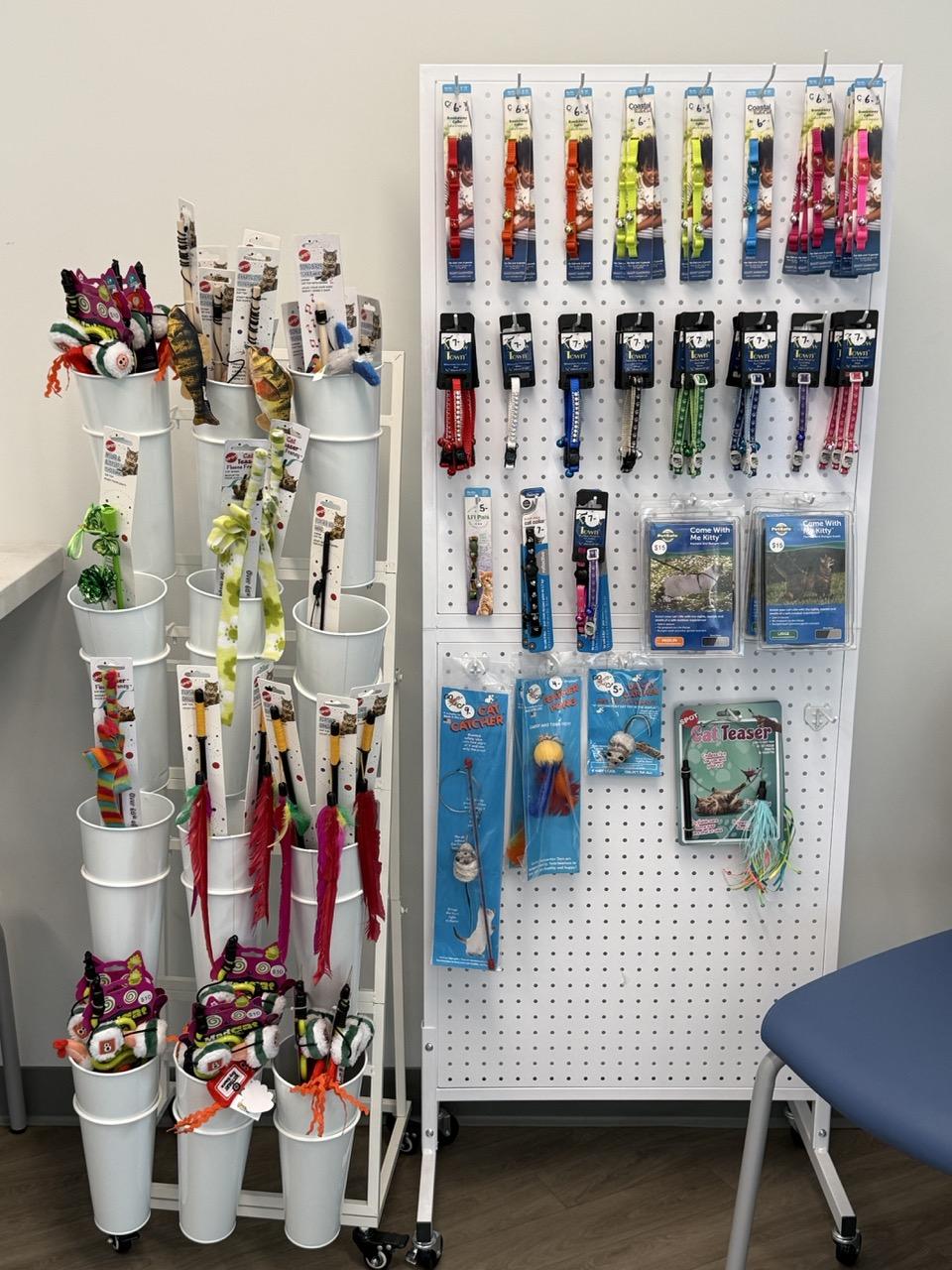 Pet store display with colorful dog leashes, collars, toys, and accessories on racks.