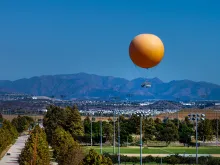 great park balloon flying above the park with mountains in the background