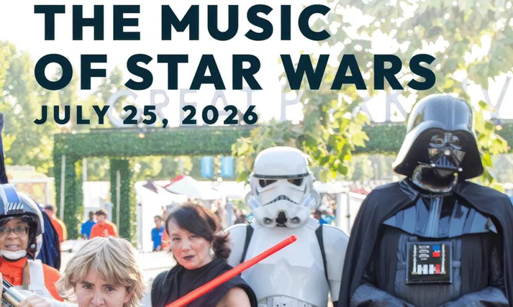 Darth Vader, Stormtrooper, and Luke cosplayers with lightsabers at an outdoor event.