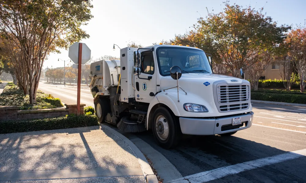 Street sweeper on a street at a stop sign