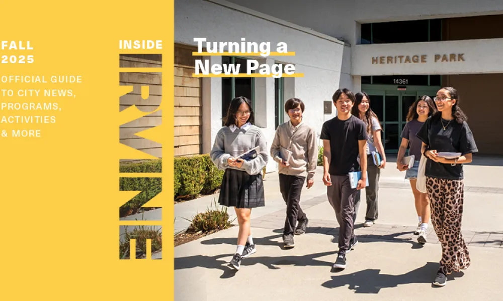 Diverse students walk past Heritage Park building on a sunny day.
