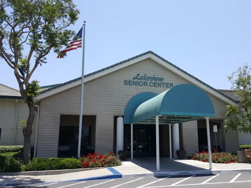 Photograph: Lakeview Senior Center entrance, green awning, American flag, on a sunny day.
