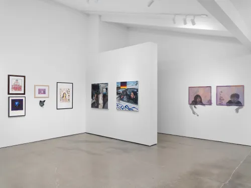 Contemporary art gallery with diverse paintings and framed artworks displayed on white walls.