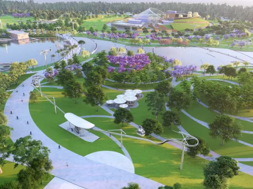 Aerial view of a modern park with lakes, green spaces, purple trees, paths, and white shelters.